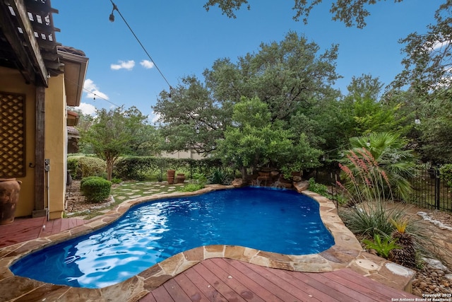 view of pool featuring a fenced in pool, a wooden deck, and a fenced backyard