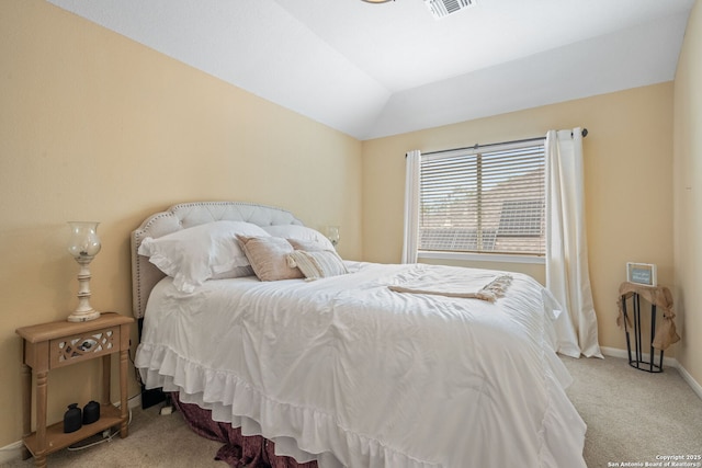 bedroom with baseboards, visible vents, lofted ceiling, and carpet