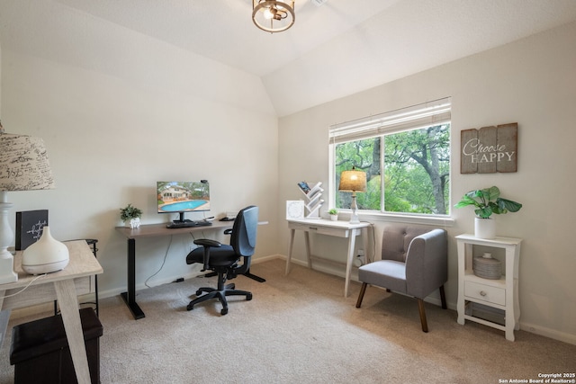 carpeted home office with baseboards and vaulted ceiling