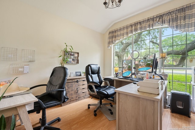 office with light wood-type flooring and lofted ceiling