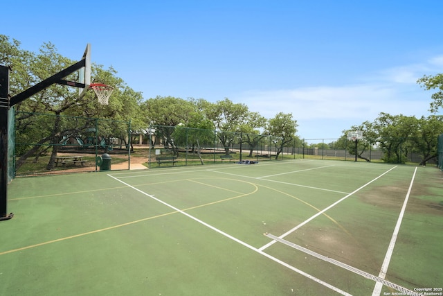 view of basketball court featuring community basketball court and fence