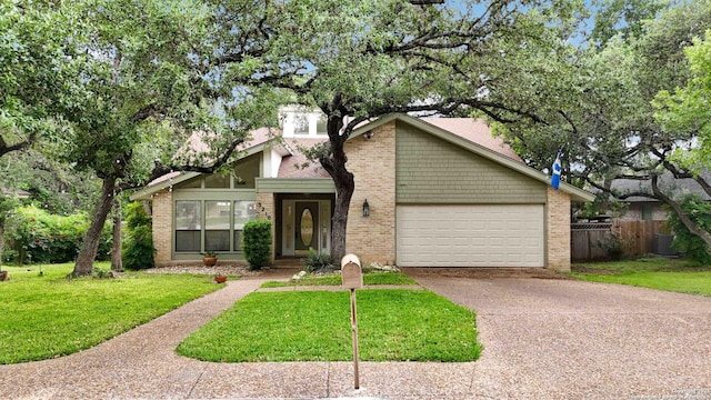 mid-century home featuring fence, a front lawn, brick siding, a garage, and driveway