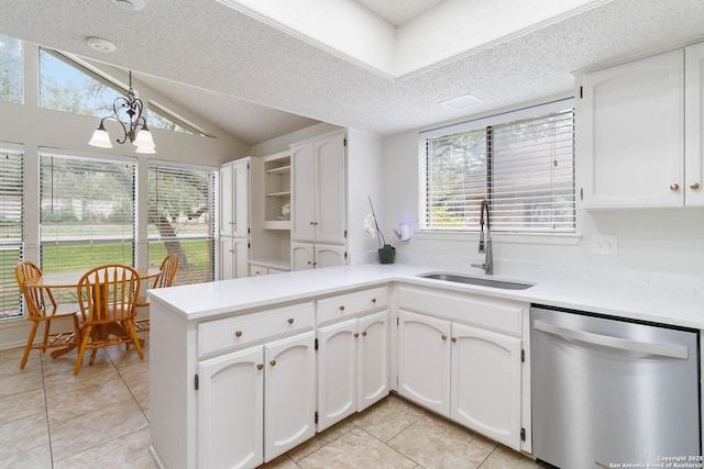 kitchen featuring white cabinets, light tile patterned floors, a sink, and dishwasher