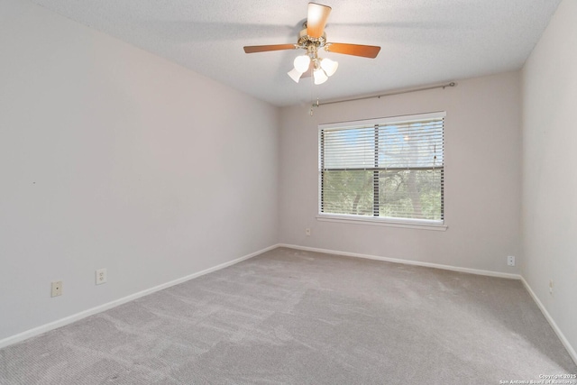 unfurnished room featuring carpet floors, baseboards, and a ceiling fan
