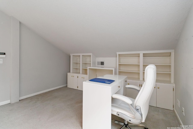 office area with vaulted ceiling, light colored carpet, baseboards, and visible vents