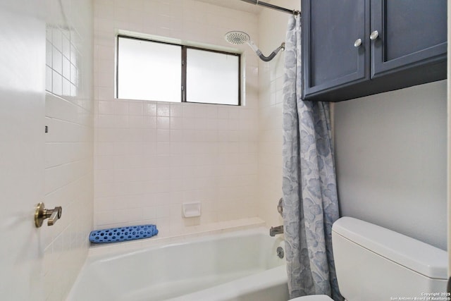 bathroom featuring shower / bath combo with shower curtain and toilet