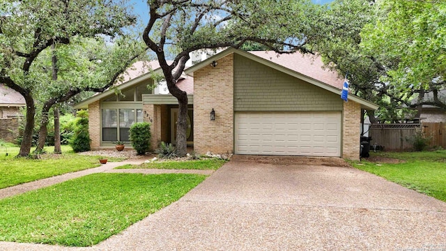 mid-century home with fence, a front yard, brick siding, concrete driveway, and an attached garage