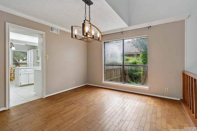 unfurnished room featuring a notable chandelier, visible vents, plenty of natural light, and light wood-style flooring