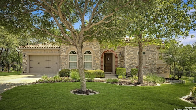 22932 Estacado, San Antonio, TX 78261 - view of front of house featuring an attached garage, stone siding, and concrete driveway