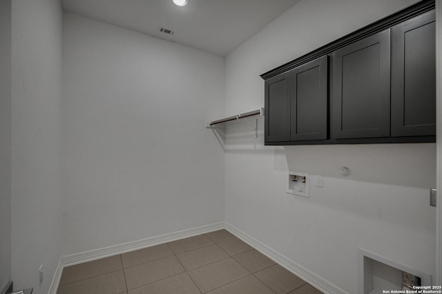22932 Estacado, San Antonio, TX 78261 - washroom featuring hookup for a washing machine, gas dryer hookup, cabinet space, baseboards, and light tile patterned floors