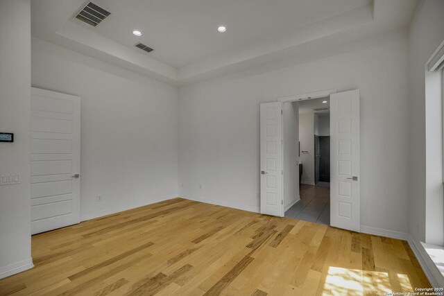 22932 Estacado, San Antonio, TX 78261 - spare room featuring a tray ceiling, light wood finished floors, recessed lighting, and baseboards