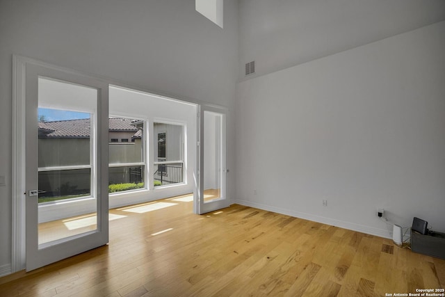 22932 Estacado, San Antonio, TX 78261 - unfurnished room with light wood-type flooring, a high ceiling, and baseboards