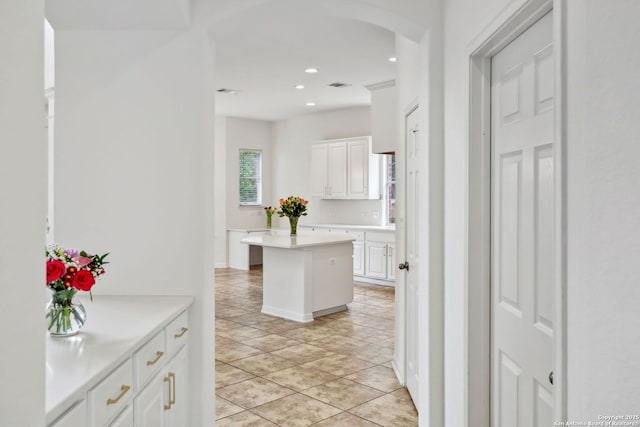 hall featuring arched walkways, recessed lighting, light tile patterned floors, and visible vents