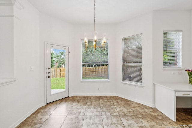 unfurnished dining area with baseboards, a chandelier, and light tile patterned floors