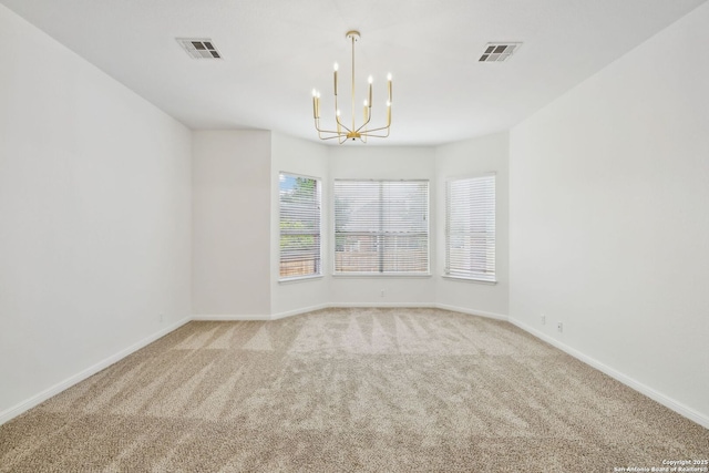 unfurnished room with visible vents, baseboards, a notable chandelier, and light carpet