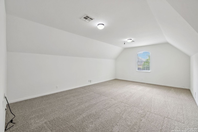 bonus room with visible vents, carpet, baseboards, and vaulted ceiling