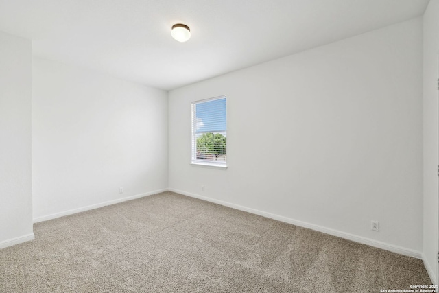 empty room with baseboards and carpet