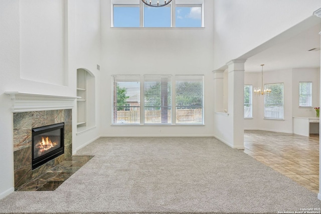 unfurnished living room with plenty of natural light and a chandelier