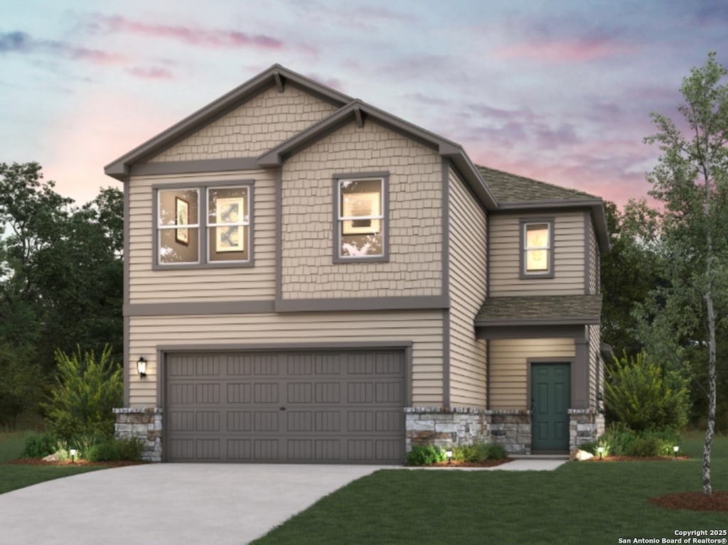 view of front of property with roof with shingles, an attached garage, stone siding, a front yard, and driveway