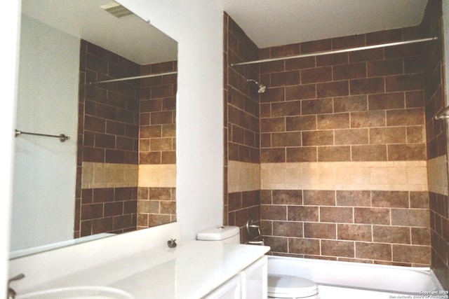 bathroom with vanity, shower / bathing tub combination, and toilet