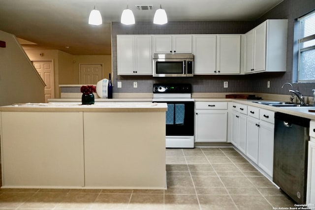 kitchen with white cabinets, appliances with stainless steel finishes, a sink, and visible vents