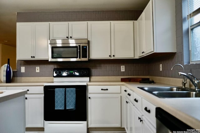 kitchen featuring light countertops, appliances with stainless steel finishes, a wealth of natural light, and a sink
