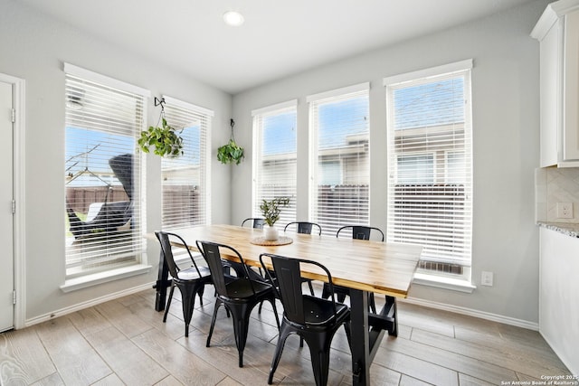 dining room featuring baseboards and light wood finished floors