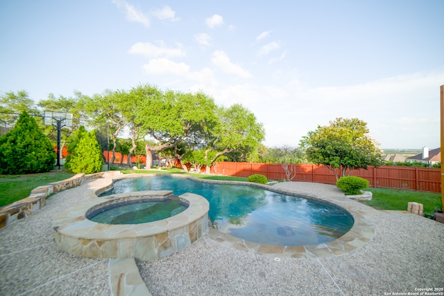 view of pool featuring a fenced backyard and a pool with connected hot tub