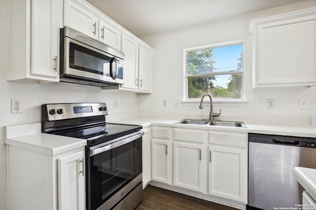 kitchen with light countertops, white cabinetry, appliances with stainless steel finishes, and a sink