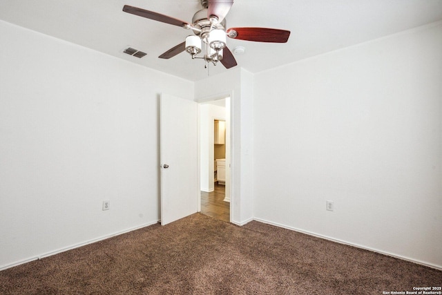 carpeted empty room featuring ceiling fan and visible vents