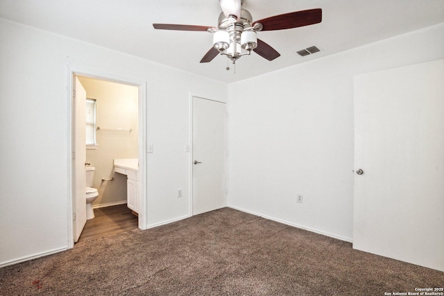 unfurnished bedroom with carpet floors, a ceiling fan, connected bathroom, and visible vents