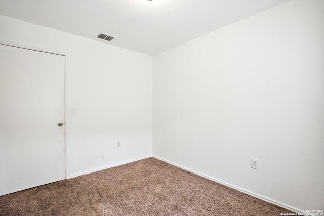 unfurnished room with visible vents, carpet flooring, and baseboards
