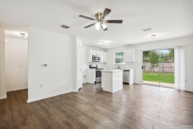 kitchen featuring ceiling fan, visible vents, appliances with stainless steel finishes, a center island, and white cabinets