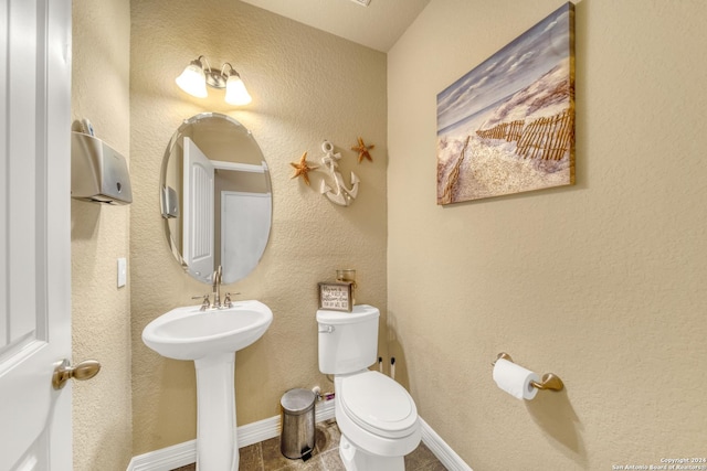bathroom featuring toilet and a sink