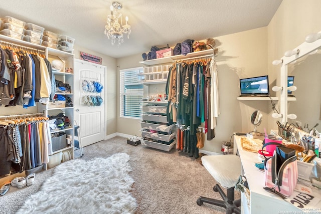walk in closet with carpet floors and a chandelier