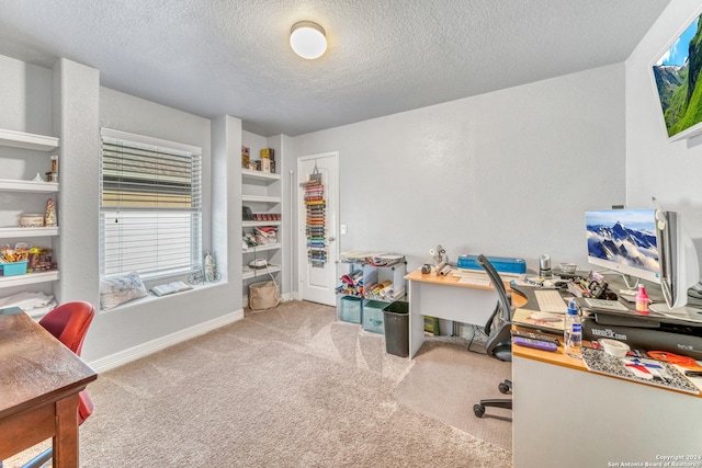 carpeted home office featuring a textured ceiling and baseboards