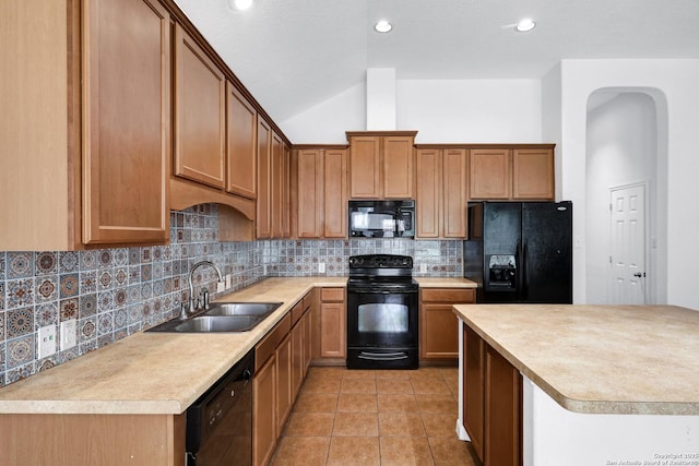 kitchen featuring light tile patterned flooring, light countertops, tasteful backsplash, a sink, and black appliances