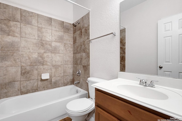 full bathroom with vanity, a textured wall, toilet, and shower / washtub combination
