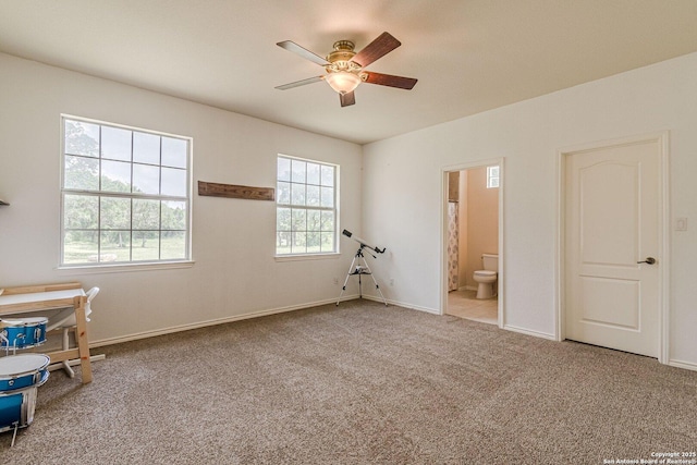 unfurnished bedroom with baseboards, carpet flooring, and connected bathroom