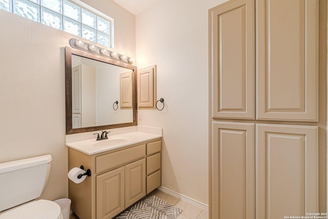 bathroom with vanity, tile patterned flooring, and toilet