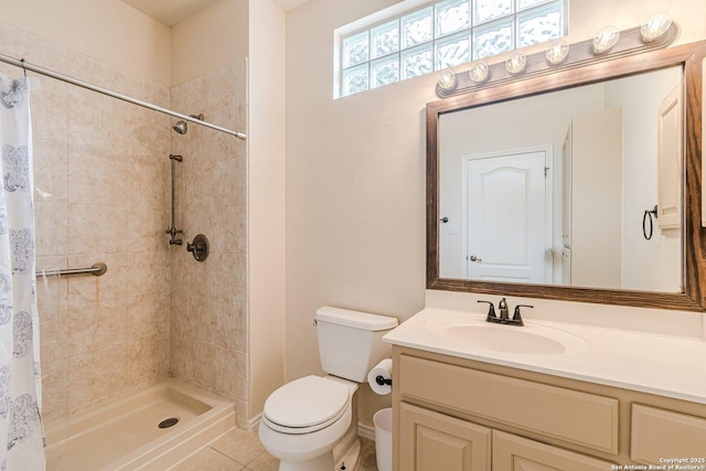 bathroom with toilet, tile patterned floors, tiled shower, and vanity