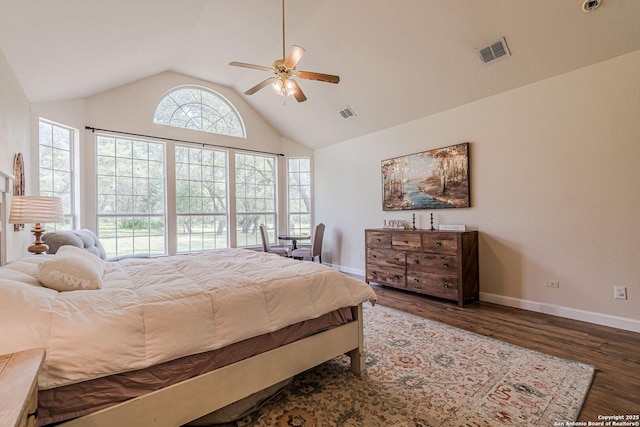 bedroom with a ceiling fan, visible vents, vaulted ceiling, wood finished floors, and baseboards