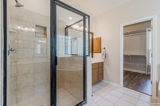 full bath with vanity, tile patterned floors, and a shower stall