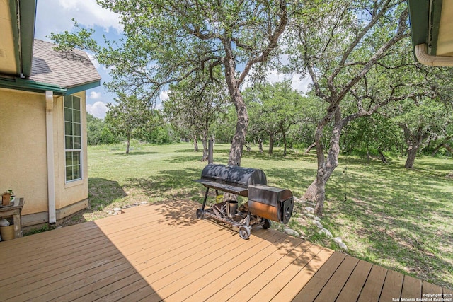 deck with a lawn and grilling area