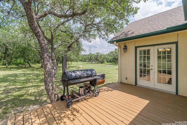 wooden deck with a lawn, french doors, and area for grilling
