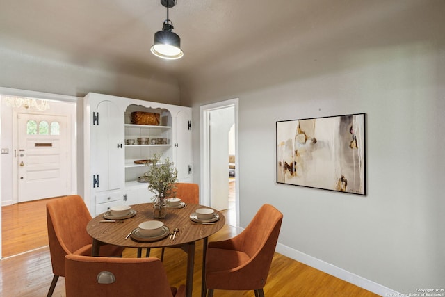 dining space with light wood-style floors and baseboards