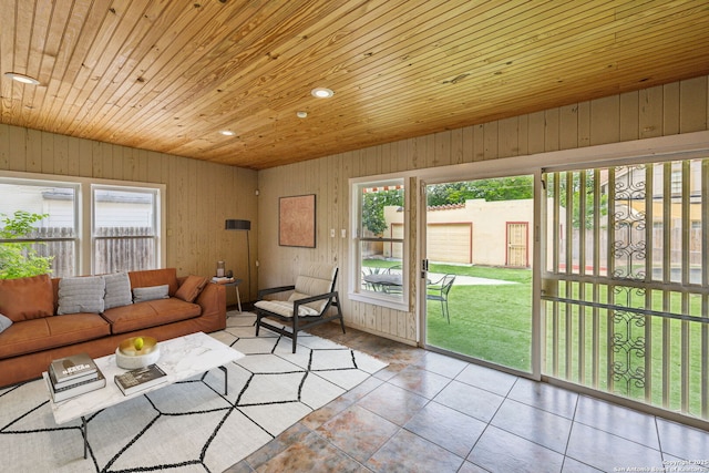 living area featuring wood ceiling, plenty of natural light, and tile patterned floors