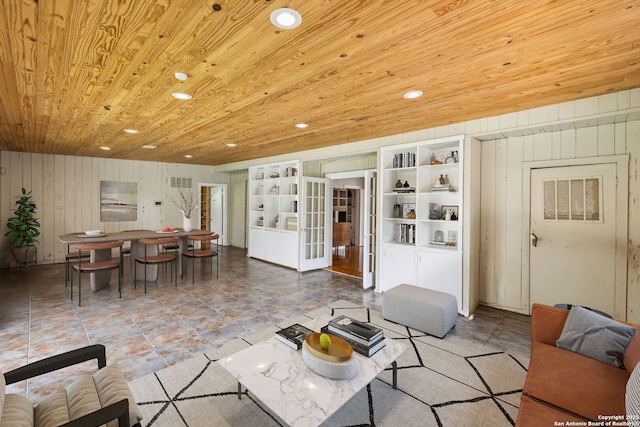 living area featuring wooden walls, recessed lighting, visible vents, and wood ceiling