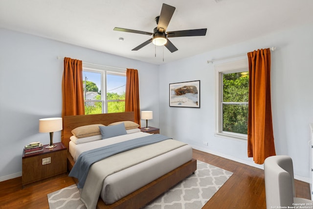 bedroom with baseboards, ceiling fan, and wood finished floors