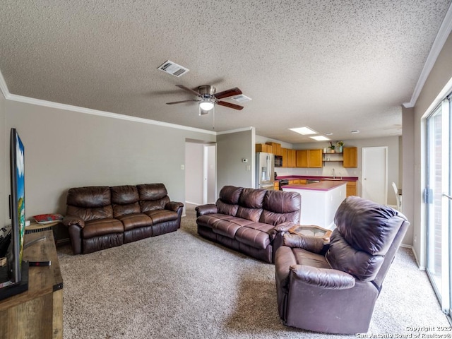 living room with ceiling fan, light colored carpet, a textured ceiling, and visible vents